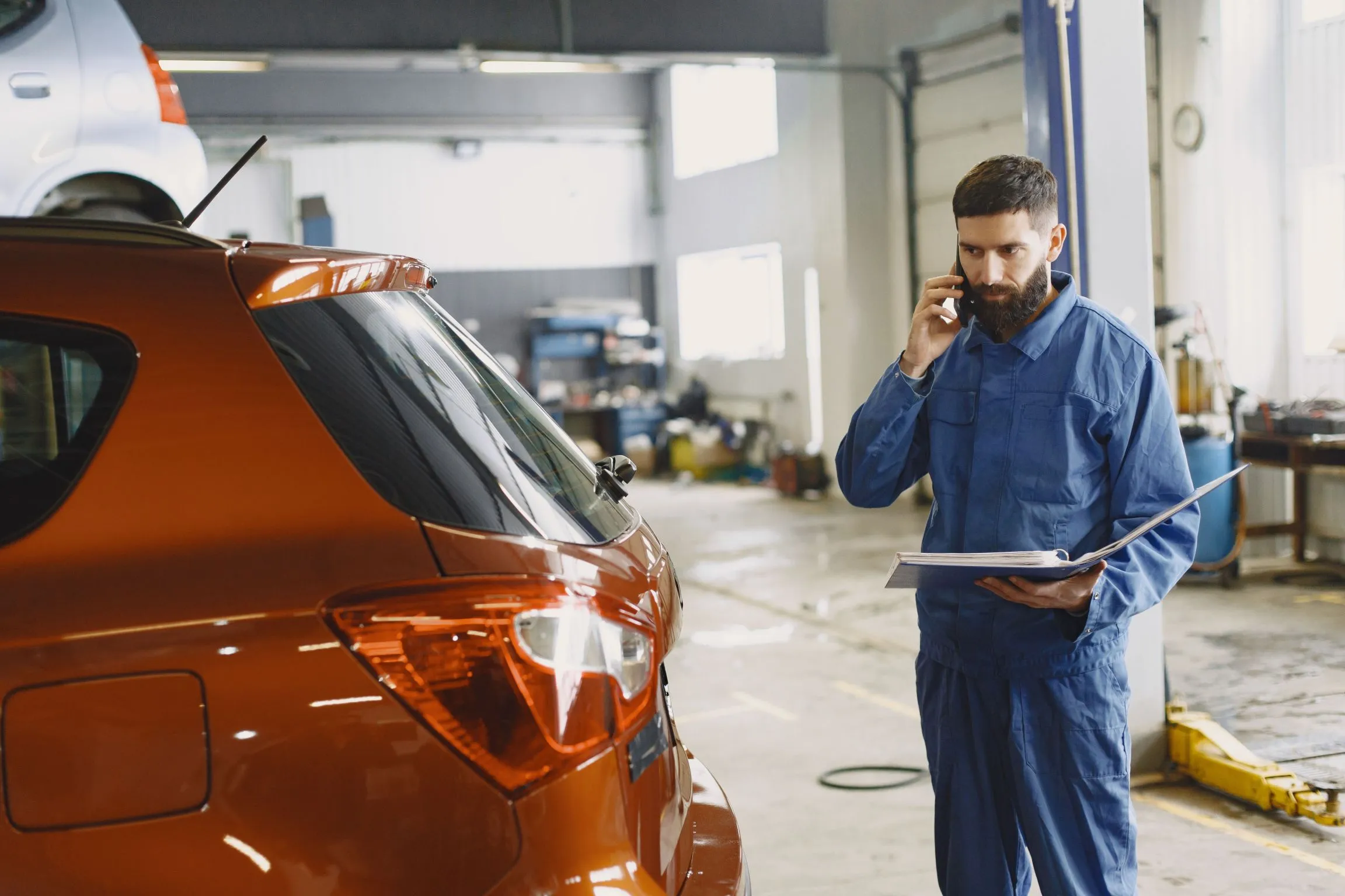 Technician reviewing a repair estimate with a customer over the phone